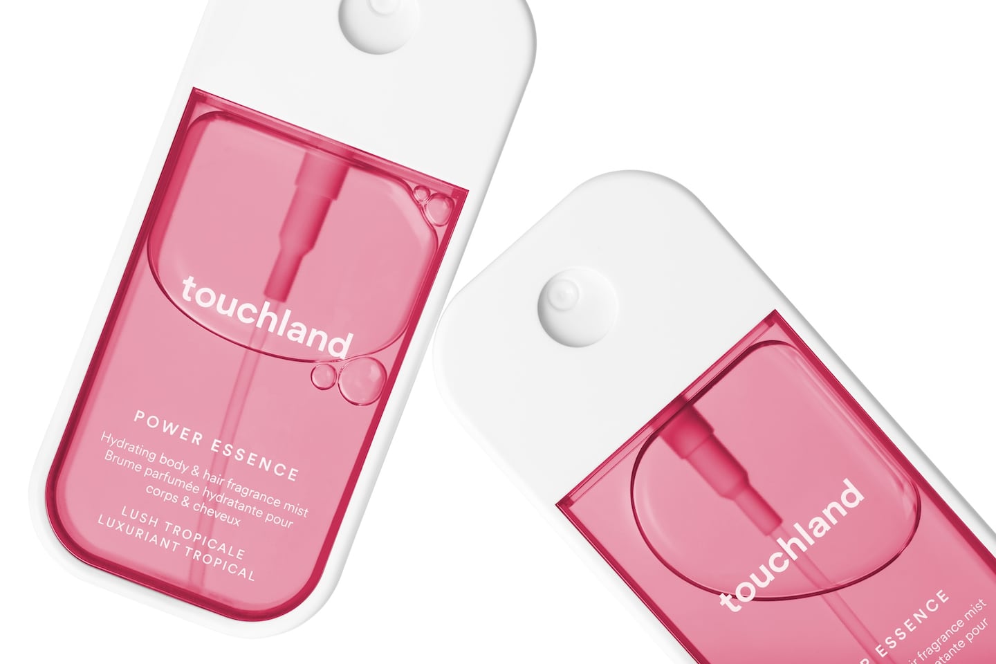 Two bottles of Touchland's new Power Essence Hair and Body Fragrance Mist are seen on a white background. Their rectangular bottle is white with a pink-tinted chamber.
