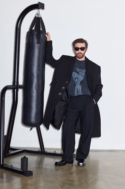 David Koma stands with his hands arched against a boxing pill.