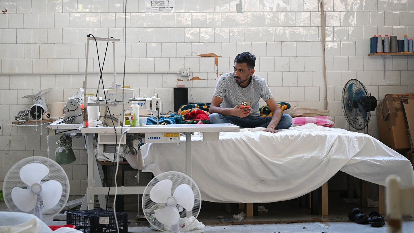 A worker rests in a fast-fashion outlet factory owned by a Chinese company in Prato, central Italy.