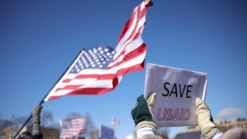 A demonstrator holds a sign reading "Save USAID" during a protest in Washington, D.C. in February, 2025.